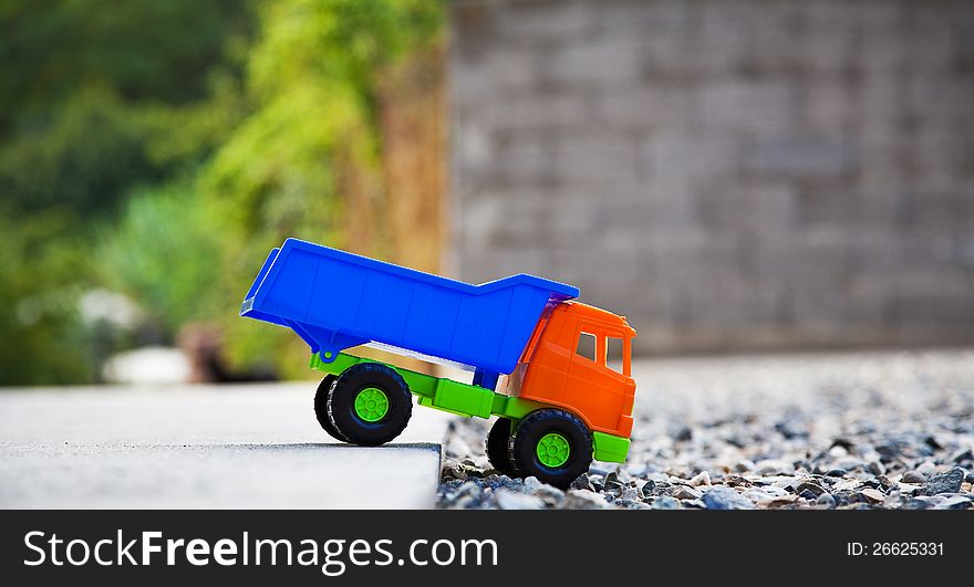 Color toy car on the gravel. Color toy car on the gravel.