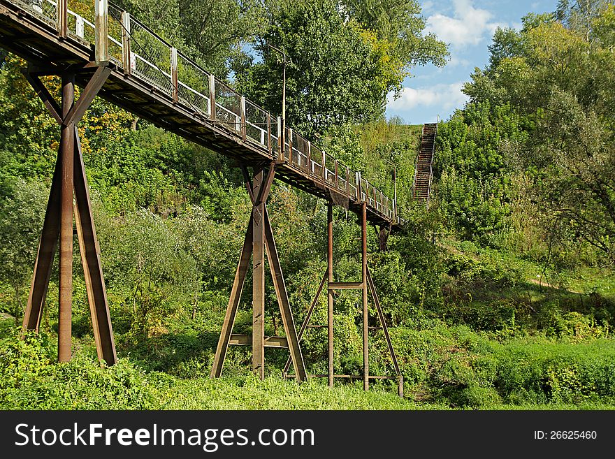The old metallic rusty footbridge