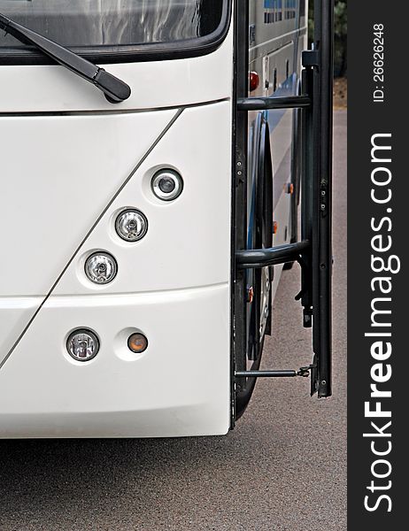 Photo of a modern coach showing round lights and open swing door. Photo of a modern coach showing round lights and open swing door.