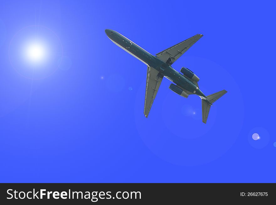 Airplane is flying through the sunlight. Airplane is flying through the sunlight