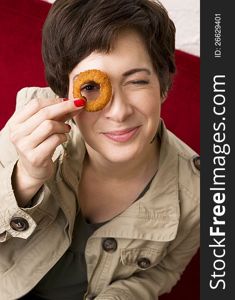 Fun Woman Holds Onion Ring To Eye Smiling