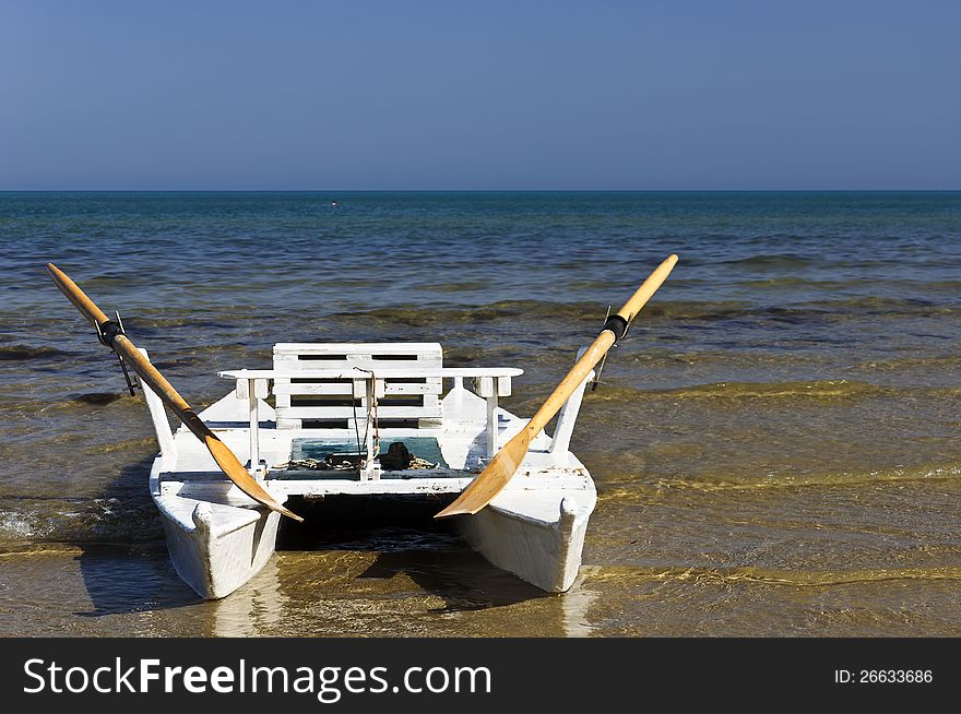 Boat on the sand in an italian sea