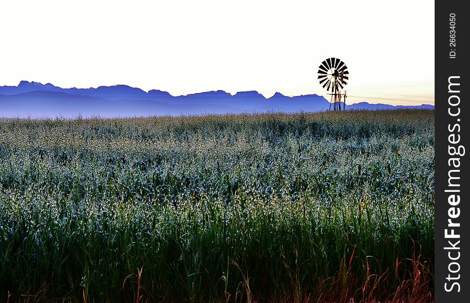 Landscape with windmill water pump at sunrise with ceres mountains