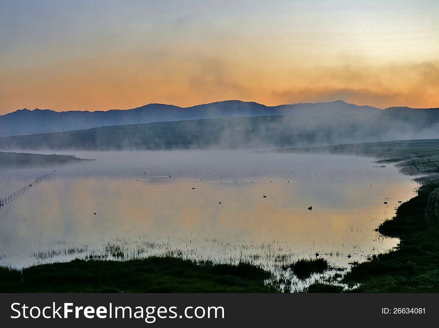 Landscape with fog over a pond with ceres mountains in the background. Landscape with fog over a pond with ceres mountains in the background