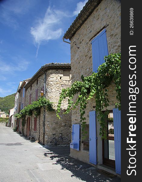 Traditional built houses with doors painted in bright colors in the French Provence. Traditional built houses with doors painted in bright colors in the French Provence