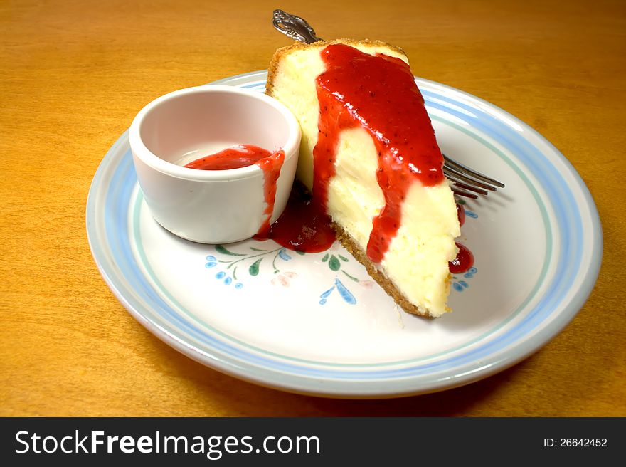 Cheesecake with strawberry glaze on table. Cheesecake with strawberry glaze on table.
