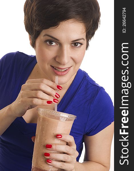 Beautiful woman with manicured nails sips a neutral colored smoothie. Beautiful woman with manicured nails sips a neutral colored smoothie