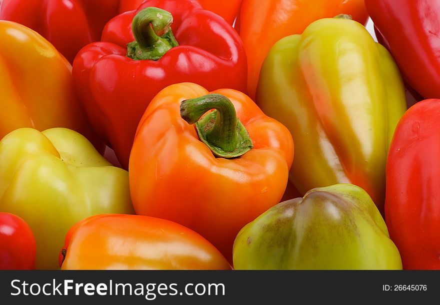 Red, Yellow, Orange and Green Bell Peppers Background close up