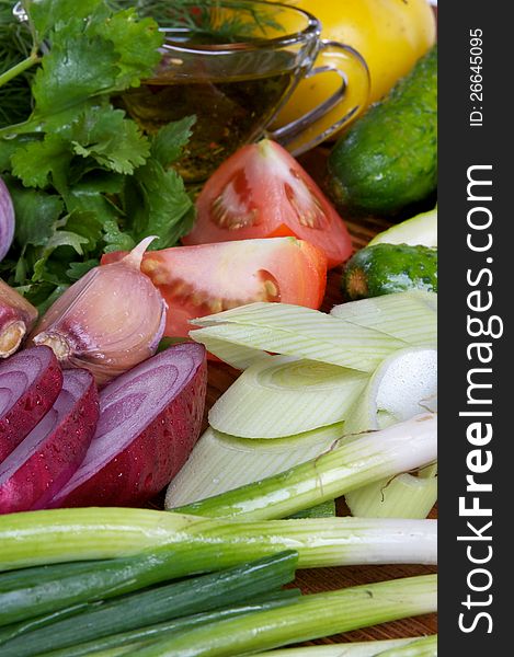 Ingrediens of Vegetable Salad with Olive Oil close up as background. Ingrediens of Vegetable Salad with Olive Oil close up as background