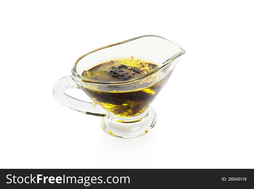 Olive Oil with Herbs in Glass Gravy Boat isolated on white background