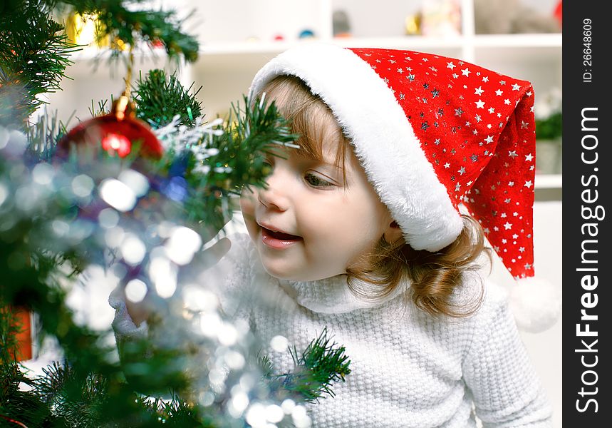 Portrait of a beautiful girl on a background of the Christmas tree. Portrait of a beautiful girl on a background of the Christmas tree