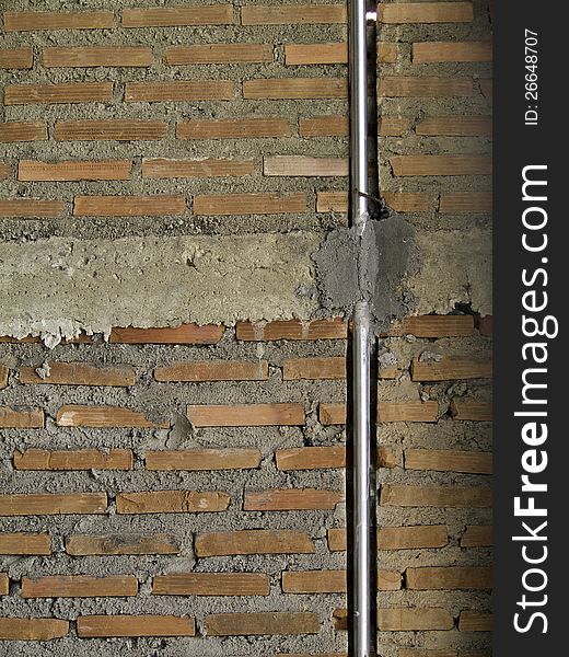 Brick Wall With Metal Pipe.