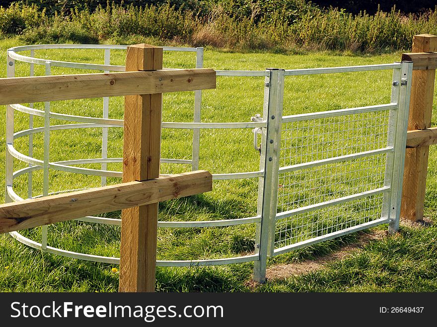 New metal kissing gate round playing fields by grazing area. New metal kissing gate round playing fields by grazing area.