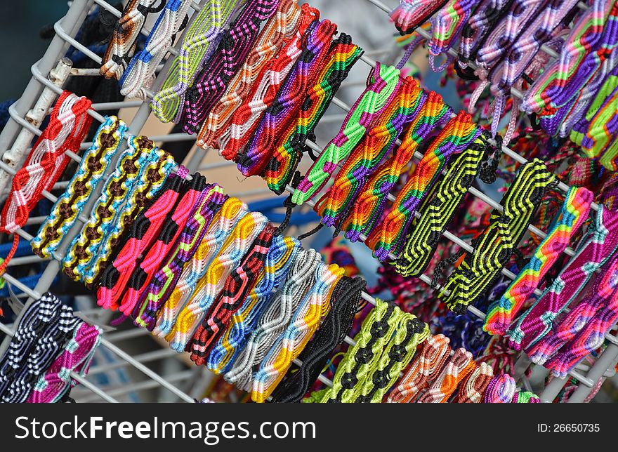 Colorful woven wristbands on display at market. Colorful woven wristbands on display at market