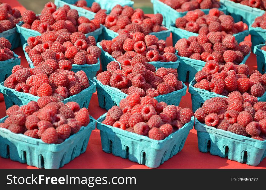 Fresh raspberries on display at the market