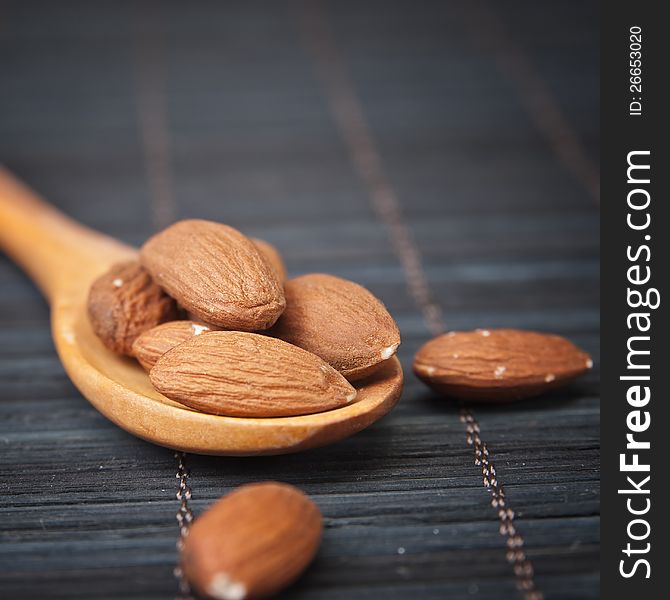 Macro shot of Almonds in a wooden spoon