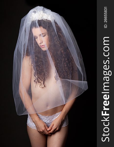 An image of a beautiful young woman wearing only a long veil and a pair of lacy underwear. An image of a beautiful young woman wearing only a long veil and a pair of lacy underwear