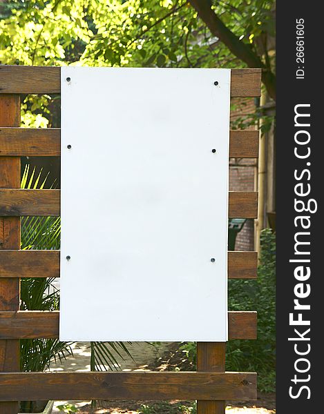 Blank signpost on wooden frame.