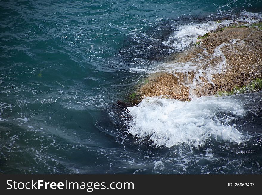 Closeup of big stone in heavy sea with waves. Closeup of big stone in heavy sea with waves