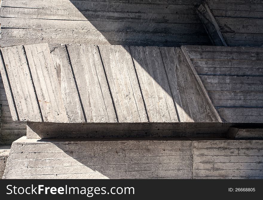 Abstract geometric concrete background illuminated by sun