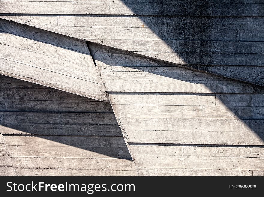 Abstract geometric concrete background illuminated by sun