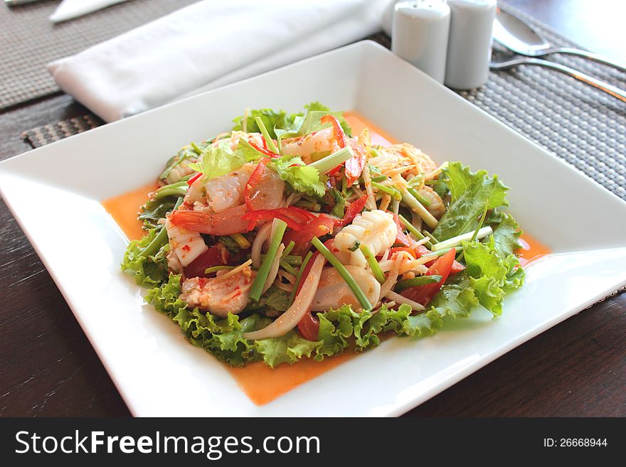 Seafood salad in the white plate rectangle. Seafood salad in the white plate rectangle