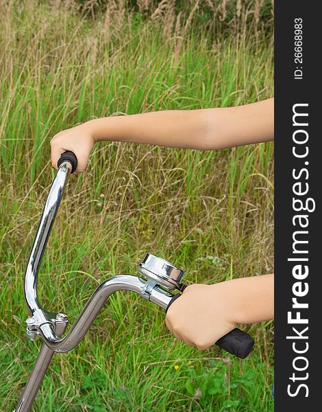 Bicycle wheel in hands at the child. Closeup