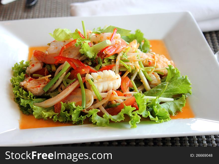Seafood salad in the white plate rectangle. Seafood salad in the white plate rectangle