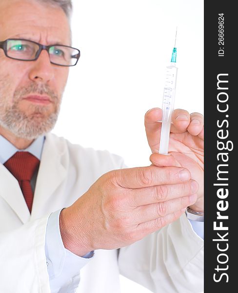 Image presents a doctor in white coat, getting ready for vaccination â€“ he holds a syringe full of vaccine. Background white.