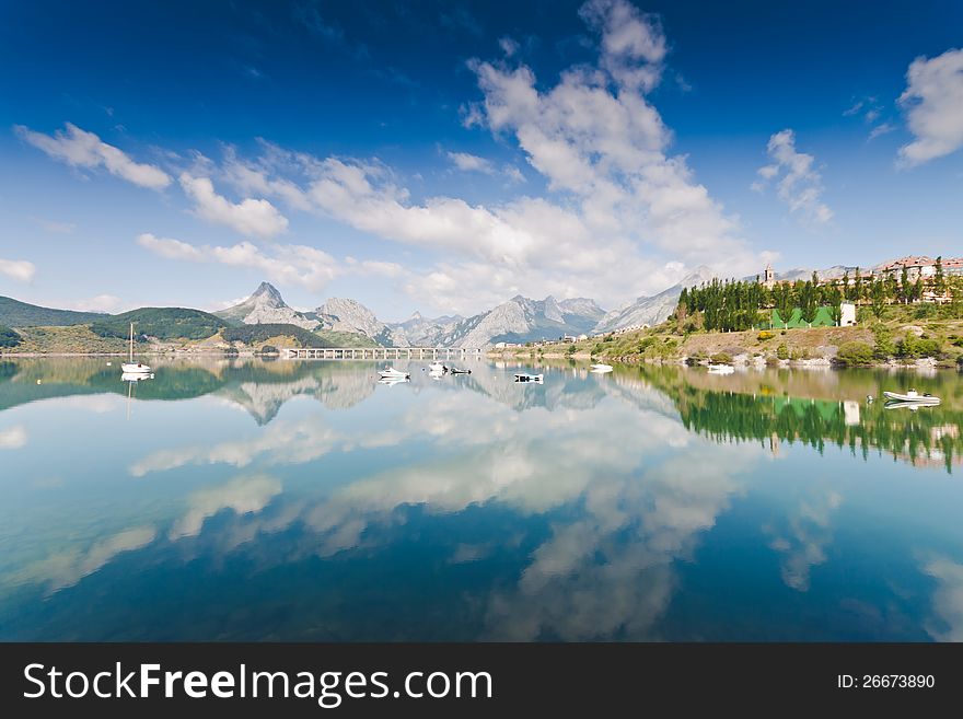 Mirror mountain lake with boats in riaÃ±o. Mirror mountain lake with boats in riaÃ±o