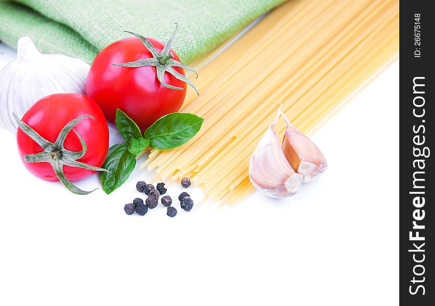 Pasta, spices and vegetables on a white background. Pasta, spices and vegetables on a white background