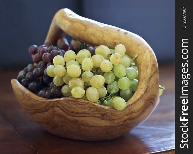 Fresh grapes served in a wooden bowl. Fresh grapes served in a wooden bowl