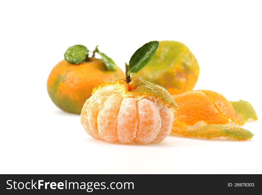 Naturally ripened peeled tangerine on a white background.