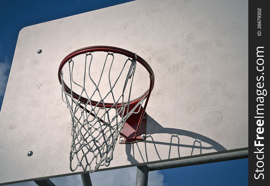 A basketball hoop at an urban park.