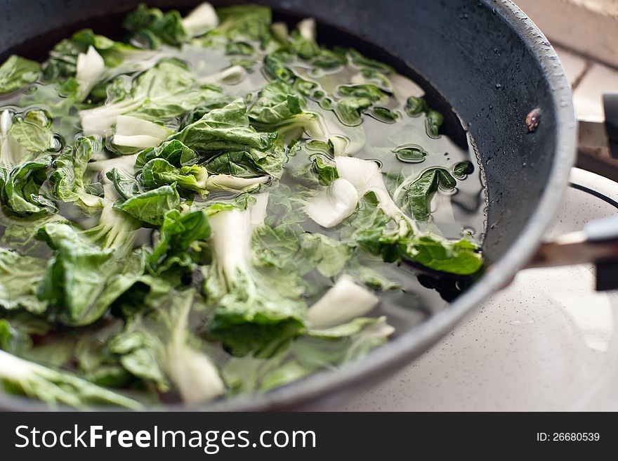 Fresh vegetables soaking in the wok