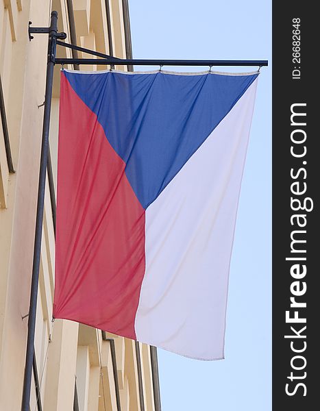 A flag of the Czech Republic waving on the wall of a building from the old city of Prague. A flag of the Czech Republic waving on the wall of a building from the old city of Prague