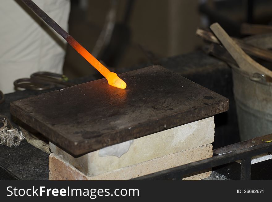 A hot glass drop being turned into a decoration in a small glass manufacture in old Prague, Czech Republic