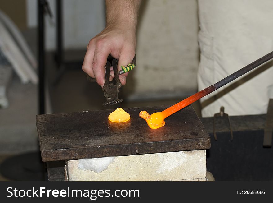 A hot glass drop being turned into a glass decoration in a small glass factory in Prague, Czech Republic