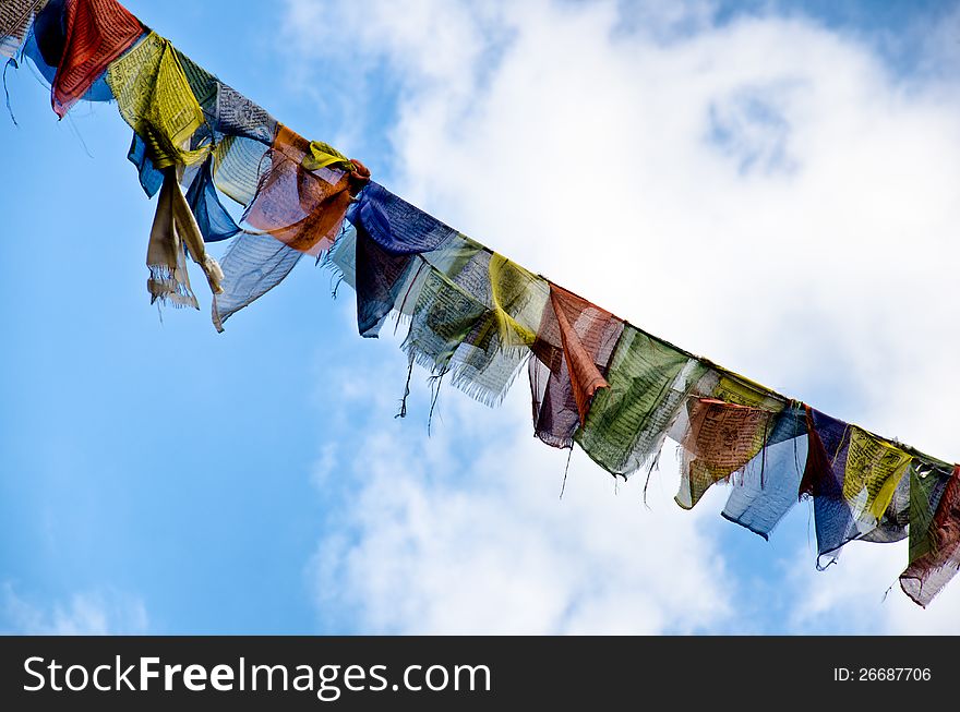 Multicolored Buddhist flags blow prayer iin the wind. Multicolored Buddhist flags blow prayer iin the wind
