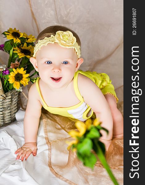 Baby is looking interested and try to reach the flower. Baby is looking interested and try to reach the flower