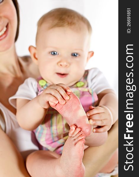 Baby catching its feet on mother's hands; focused on feet. Baby catching its feet on mother's hands; focused on feet
