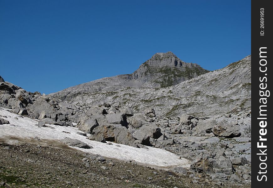 Rocks And Snowfield In The Alps