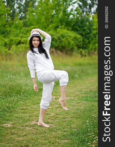 A young woman posing on the path throw meadows. A young woman posing on the path throw meadows