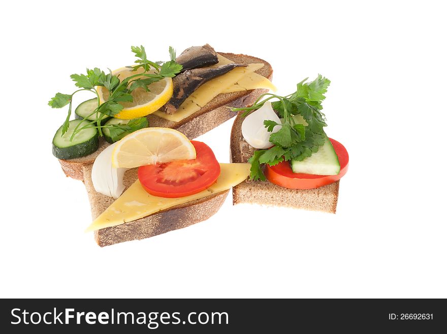 Three bits rye-bread with canned fish, tomato and cheese. Isolated on a white background. Three bits rye-bread with canned fish, tomato and cheese. Isolated on a white background.