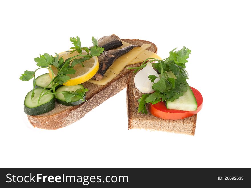 Two bits rye-bread with canned fish, tomato and cheese. Isolated on a white background. Two bits rye-bread with canned fish, tomato and cheese. Isolated on a white background.