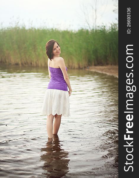 Young woman wading out of fresh water lake. Young woman wading out of fresh water lake