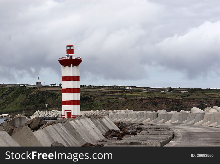 Small lighthouse maring the entrance of Praia da Vitória (Azores) harbour. Small lighthouse maring the entrance of Praia da Vitória (Azores) harbour