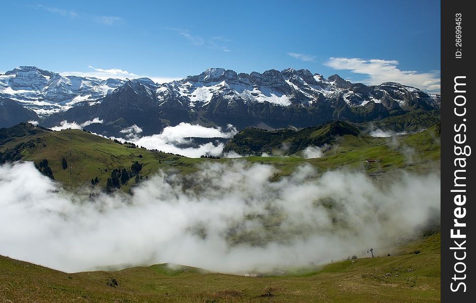 Morning mist covers the meadows of the Swiss Alps. Morning mist covers the meadows of the Swiss Alps