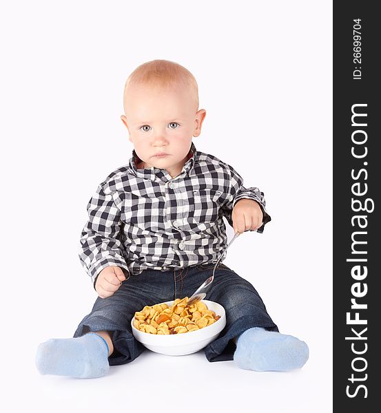 Child with a bowl of flakes on the white