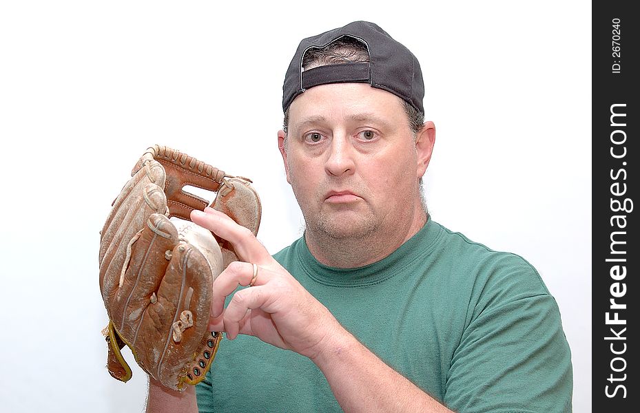 Man wearing a baseball glove and holding a ball. Man wearing a baseball glove and holding a ball.